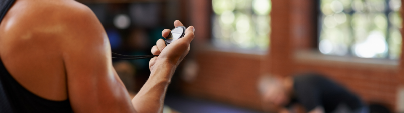 nexo_closeup trainer holding stopwatch